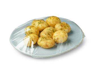 Plate of tasty boiled potatoes wrapped with stretch wrap on white background