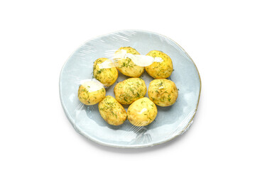 Plate of tasty boiled potatoes wrapped with stretch wrap on white background
