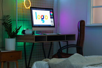 Table with modern computer and VR glasses in children's bedroom