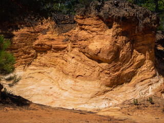 Abstract Rustrel canyon ocher cliffs landscape. Provencal Colorado near Roussillon, Southern France.
