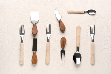 Forks, knives and spoons on light background