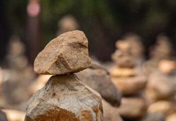 A close-up of the small pyramids made of stones in the park. Abstract Rustler canyon moher cliffs landscape. Provencal Colorado near Roussillon, Southern France. Red sand background