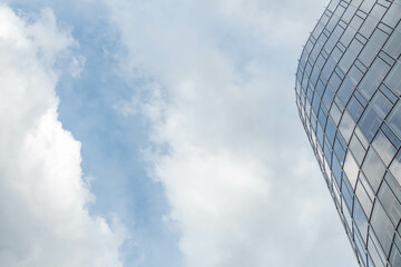 Fragment of a business office building with a sky reflected in glassed windows in Stuttgart