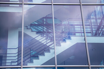 Close-up view of a staircase landing through the window of a modern business building in Stuttgart