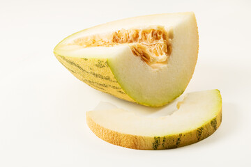 Sliced melon and melon slice on white background closeup