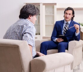 Young male patient discussing with psychologist personal problem