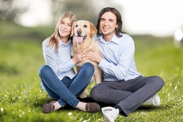 Fototapeta premium Happy young couple with cute dog at the beach