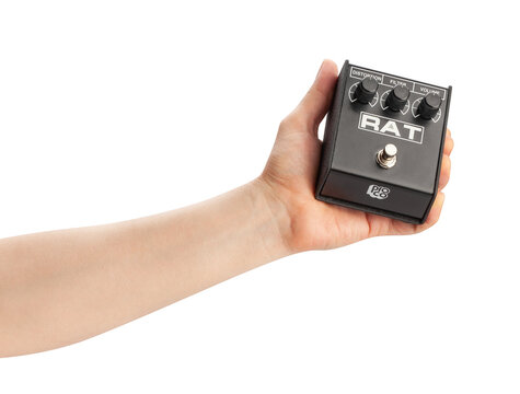 proco rat distortion guitar pedal in hand path isolated on white