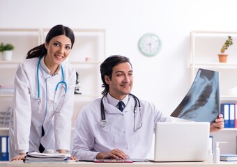 Two young doctors working in the clinic
