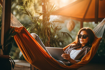 Girl lying in hammock with tablet