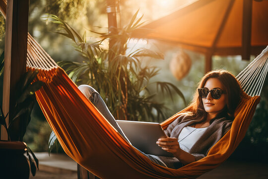 Girl lying in hammock with tablet