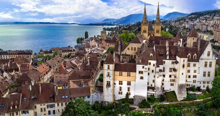 Gordijnen Switzerland travel and scenic places. Aerial drone view of Neuchatel charming town and impressive medieval castle overlooking the lake © Freesurf