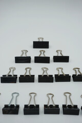 A black bulldog paperclip on a white background