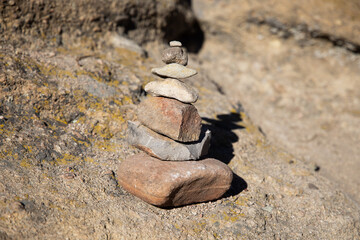stacked rock cairn on the side of a hiking trail