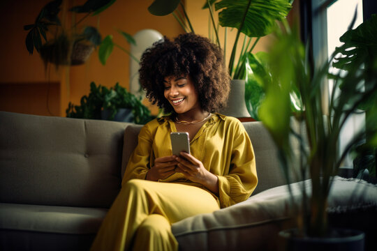 Biracial Woman On Couch With A Cell Phone