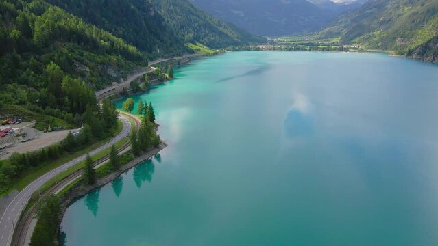Aerial drone view from Miralago of Poschiavo alpine lake and road in the Switzerland mountains. Swiss Alps