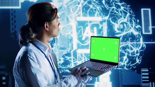 Engineer using mockup laptop to implement artificial intelligence parallel processing. Qualified administrator works on green screen device, enabling AI systems to process machine learning data