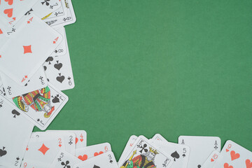 Playing cards isolated on green background.