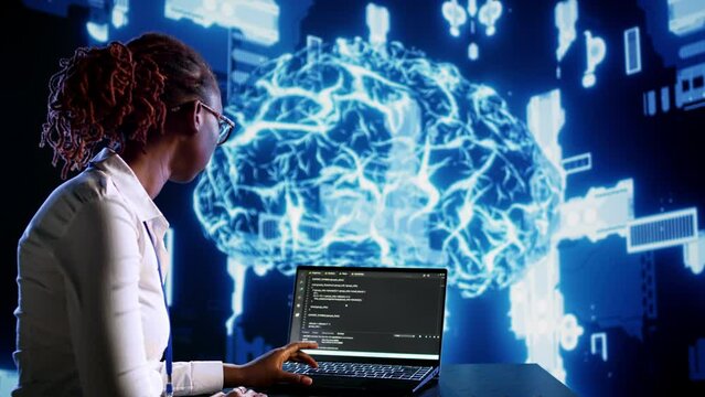 African american IT expert updating AI systems, writing intricate binary code scripts on tablet and laptop. Certified admin using programming to upgrade artificial intelligence simulation model