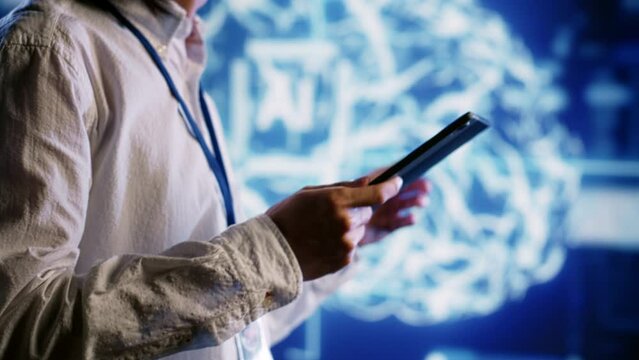 Qualified admin works with artificial intelligence computerized model simulating human brain. Proficient expert looks at AI visualization showing machine learning algorithms using pattern recognition