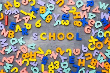 word SCHOOL is made up of multi-colored letters of the alphabet. Back to school, school education.