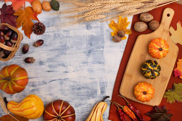 Autumn composition. Pattern of autumn leaves, pumpkins and wheat on the table. Flat lay, top view.