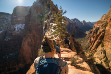 Woman taking photo of Angels Landing in Zion National Park