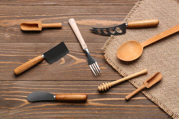 Different kitchen utensils on wooden background
