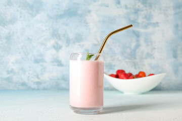 Glass of tasty strawberry smoothie on table