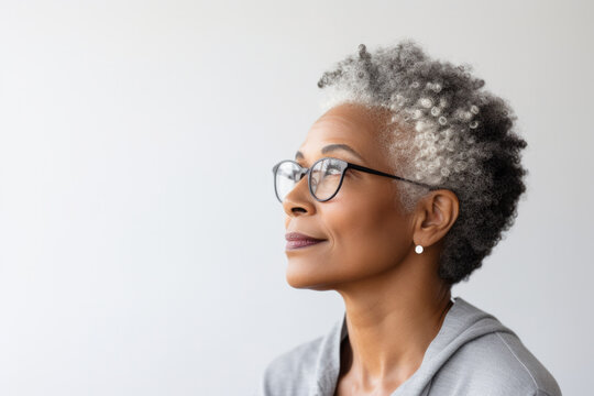 senior woman thinking with pensive expression against wall background - Powered by Adobe