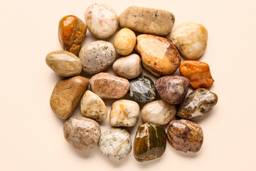 Many pebble stones on beige background