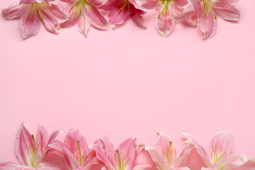 Frame made of beautiful lily flowers on pink background