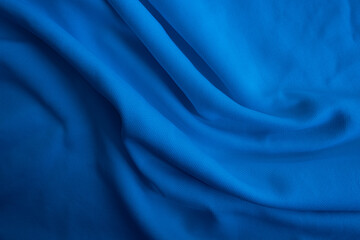 Blue fabric background. Abstract blue wavy cloth.