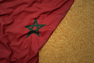 wheat grain on the waving colorful big national flag of morocco .