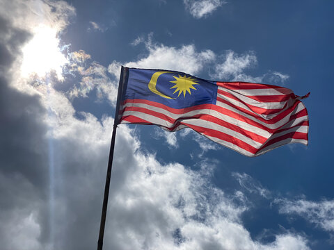 Malaysia waving flag with sky background. Independence day concept.