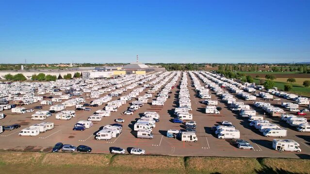 Many motorhomes in parking lot view from above in annual exhibition of camper vans (Salone del Camper). Best option for travel feeling free. Parma, Italy - September 17, 2022. 4K video