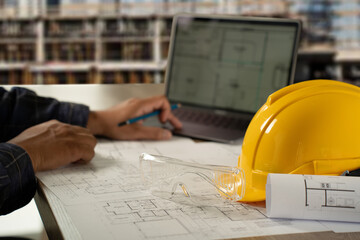 Man, architect, and engineer work discussing tools and construction concepts on a building site with blueprints for a professional construction job and building contractor development.