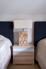 wooden lamp on the bedside table, eco-house concept, hotel, minimalist interior