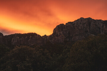 Orange Skies Light Up Clouds Above the Chisos Mountains