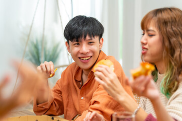 Group of Young Asian man and woman friends having dinner party eating food and drinking soft drink...