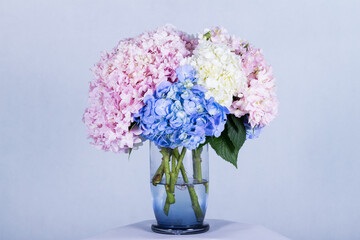 Many kinds of beautiful flowers put in vase on a white background