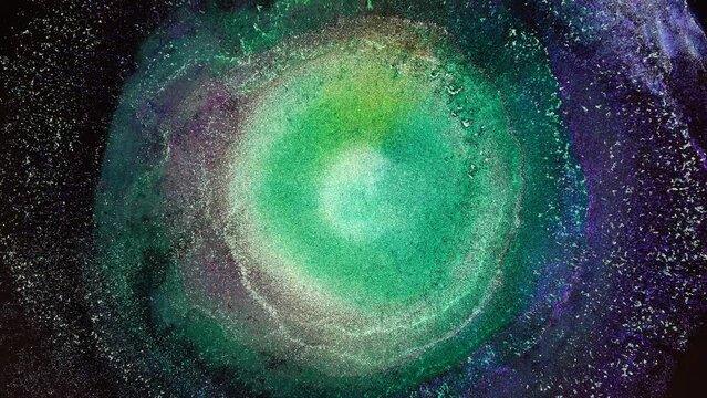 Green purple color abstract magic space background. Chemical reaction macro. Explosion and splash of colors
