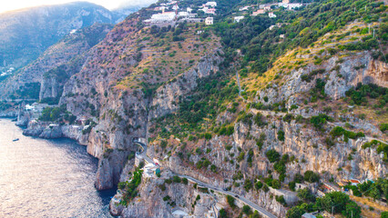 Fototapeta na wymiar The Amalfi Coast is a breathtaking stretch of coastline in southern Italy, known for its vertiginous cliffs adorned with colorful villages, turquoise waters, and lush terraced gardens. 