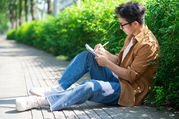 Obraz premium Portrait of young Asian man outside