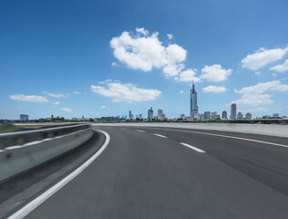 Empty urban asphalt road exterior with city buildings background. New modern highway concrete construction.