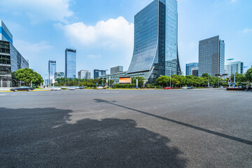 empty asphalt floor with city skyline