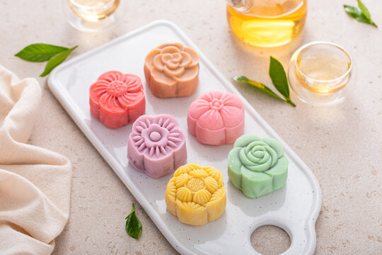 Traditional Chinese snow skin mooncakes for mid autumn festival with fruit, taro and matcha filling