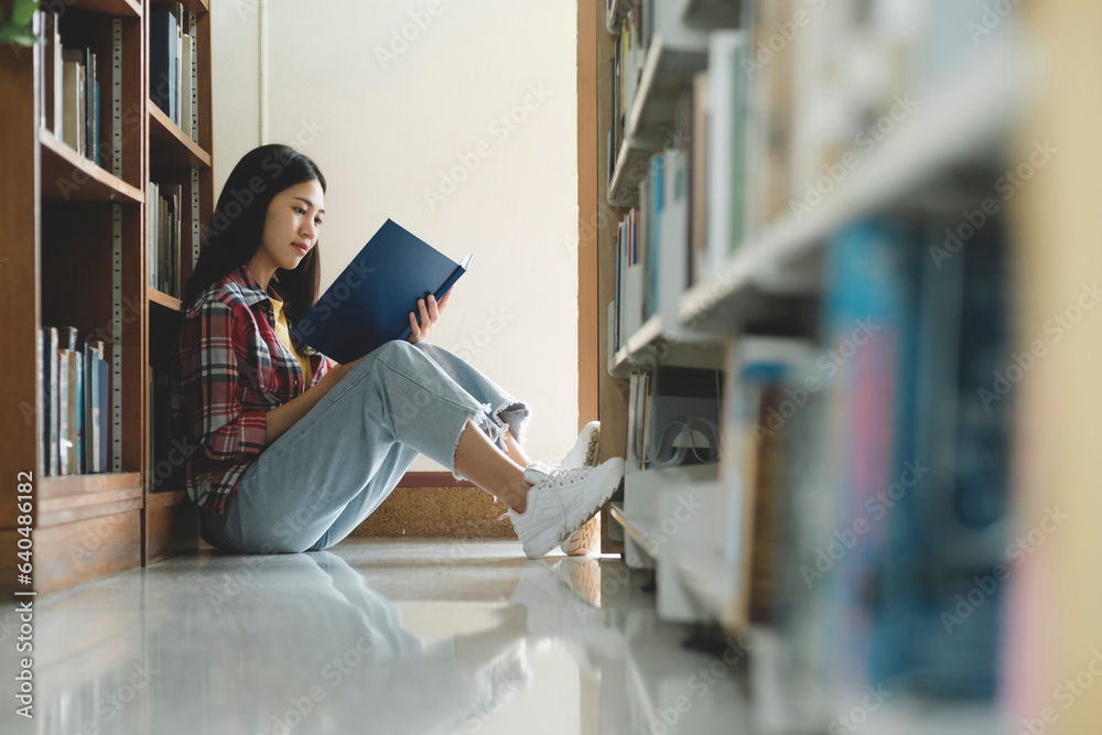 Poster university students reading books in library for research.