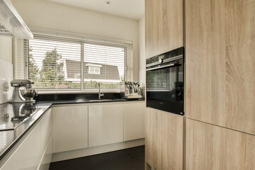 a modern kitchen with white cabinets and black counter tops on the island in front of the sink is made out of wood