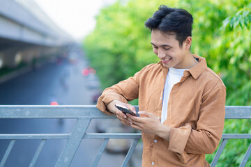 Portrait of young Asian man outside
